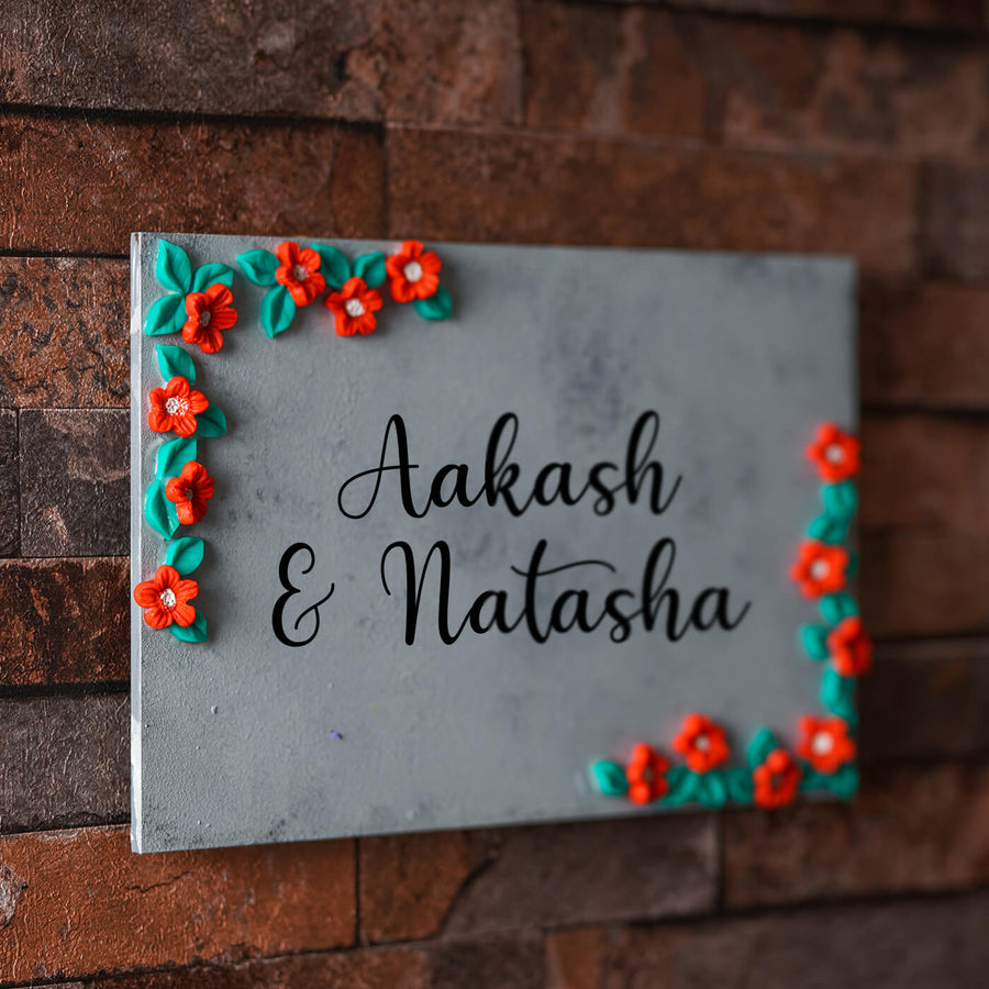 Clay Name Plate For Couples Red Green Florals - Mounted on Brick Wall Close-up