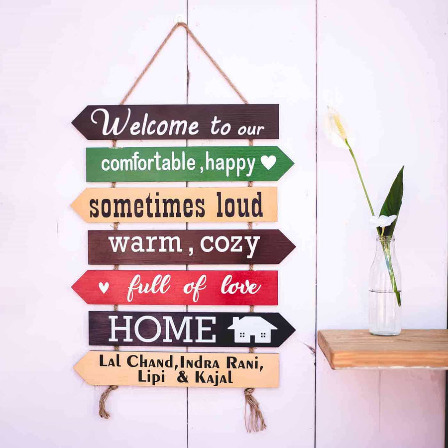 Welcome Board With Four Names - Hanging on White Wooden Wall