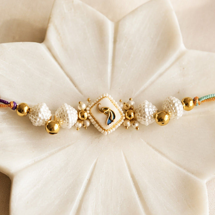 Hand-Knotted White Meenakari Beaded Ghunghroo Rakhi With Roli Chawal For Brother