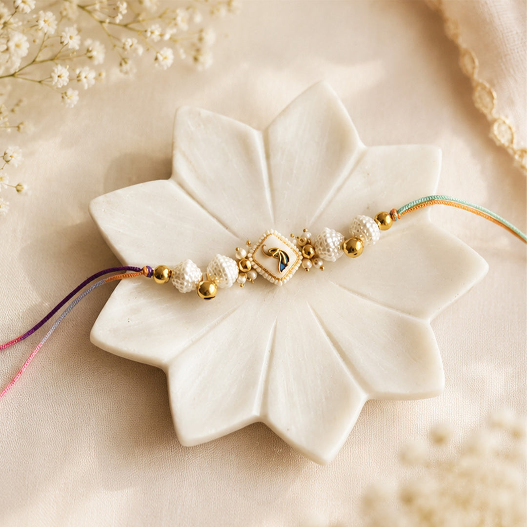 Hand-Knotted White Meenakari Beaded Ghunghroo Rakhi With Roli Chawal For Brother