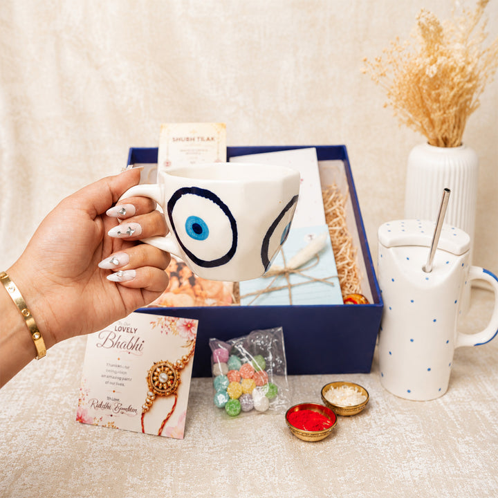 "Nazar Se Surakshit" Evil Eye Ceramic Rakhi Hamper With Mug, Sipper & Roli Chawal For Brother