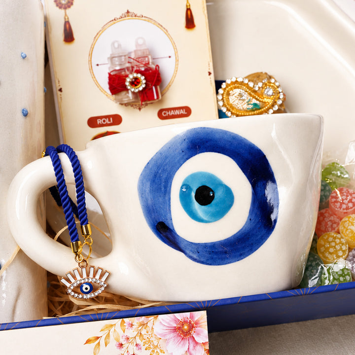 "Nazar Se Surakshit" Evil Eye Ceramic Rakhi Hamper With Mug, Sipper & Roli Chawal For Brother