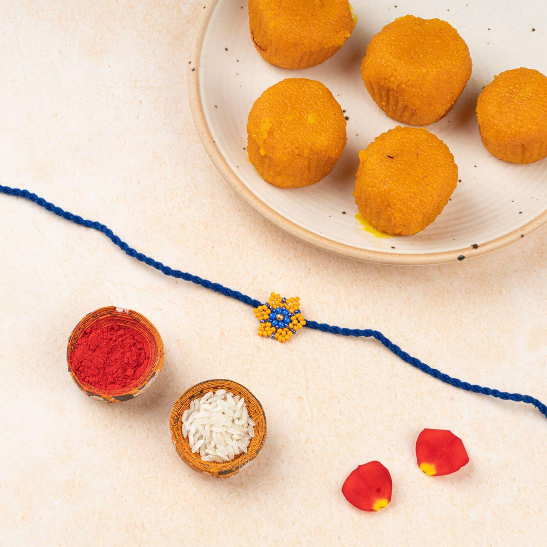Handcrafted Glass Beads Sitara Rakhi 8 - Rakhi with traditional items nearby