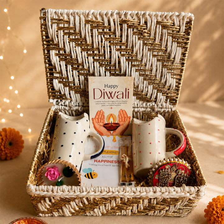 Ruby & Azure Golden Basket Diwali Gift Hamper With Red And Blue Tumbler And Small Urli Candle For Festive Gifting