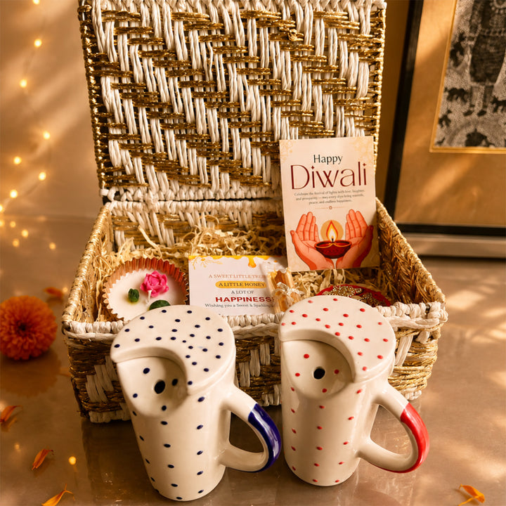 Ruby & Azure Golden Basket Diwali Gift Hamper With Red And Blue Tumbler And Small Urli Candle For Festive Gifting