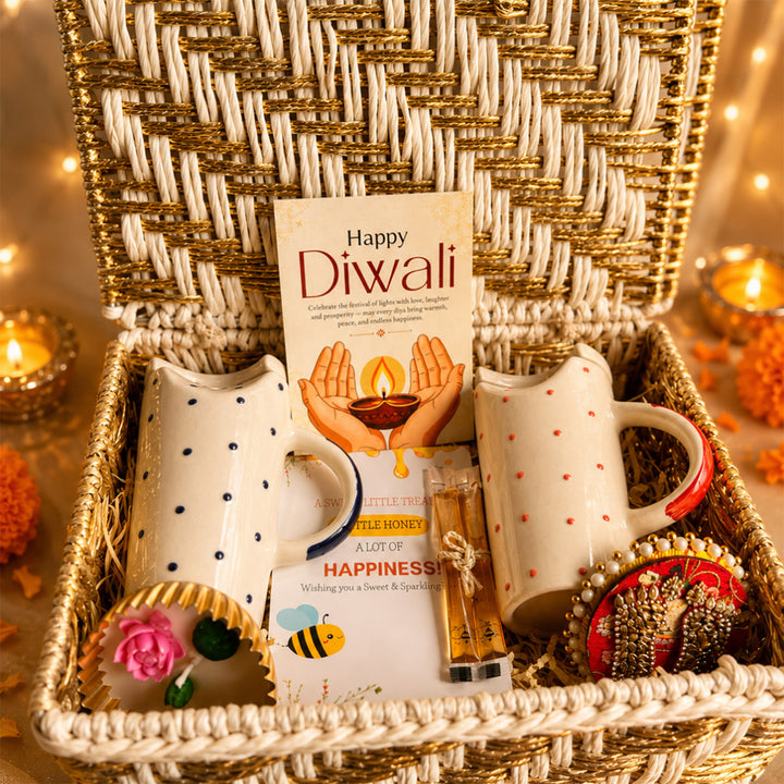 Ruby & Azure Golden Basket Diwali Gift Hamper With Red And Blue Tumbler And Small Urli Candle For Festive Gifting