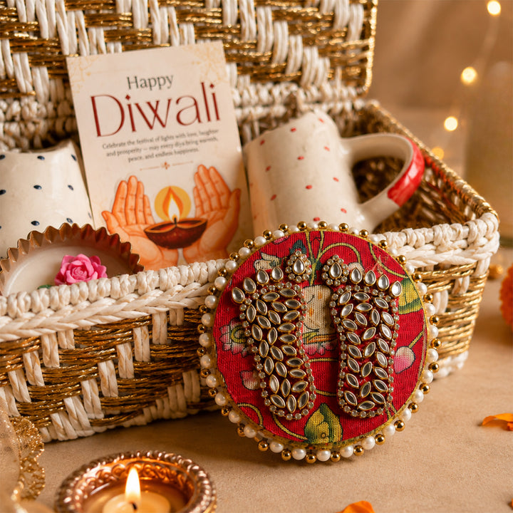 Ruby & Azure Golden Basket Diwali Gift Hamper With Red And Blue Tumbler And Small Urli Candle For Festive Gifting