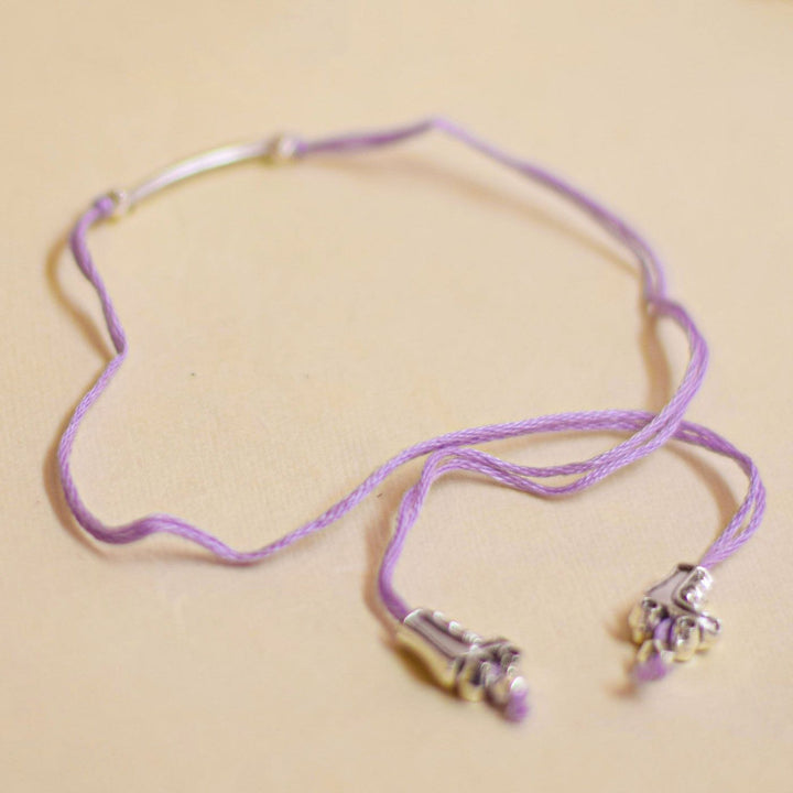 Handmade Stake Board Shoe And Pearl Design Rakhi With Roli Chawal - Unwrapped purple string bracelet