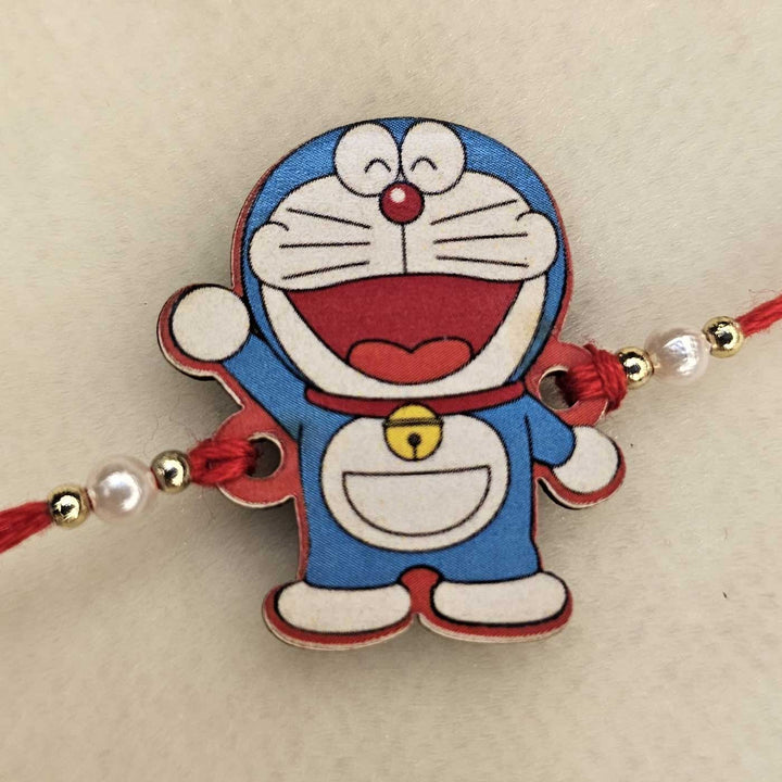 Handmade Doraemon Mdf Wood Kids Rakhi With Roli Chawal - Close-up Front View