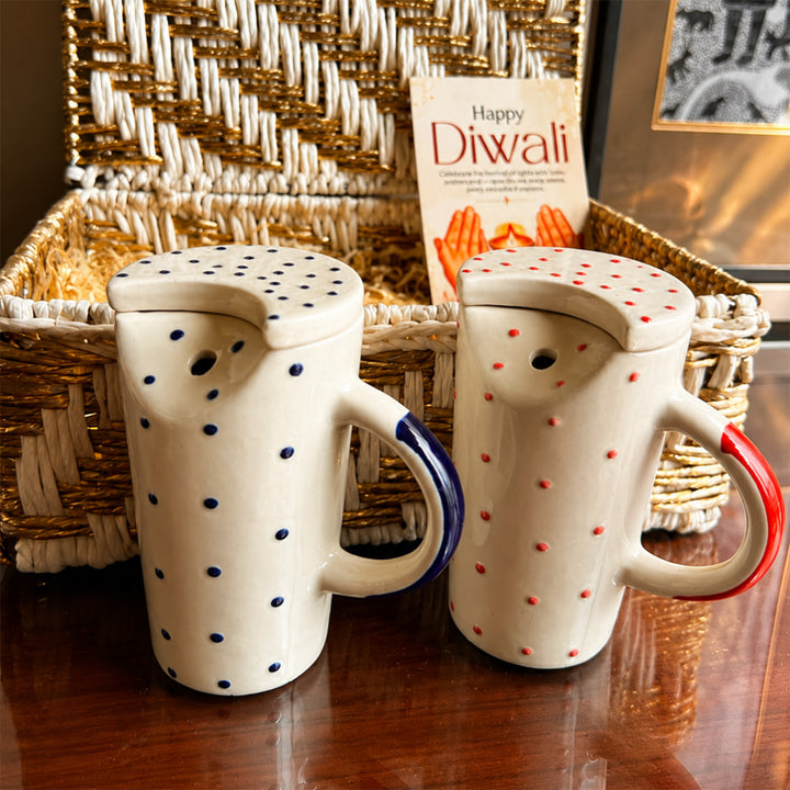 Ruby & Azure Golden Basket Diwali Gift Hamper With Red And Blue Tumbler And Small Urli Candle For Festive Gifting