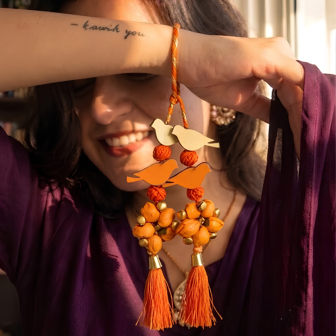 Handcrafted Bird Motif Shola Beaded Tassel Lumba Rakhi for Bhabhi - Orange