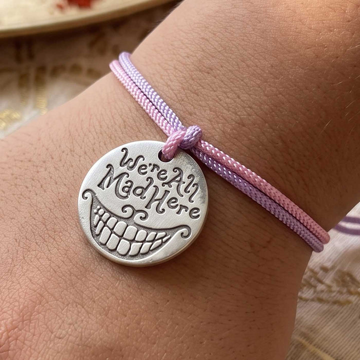 Engraved "We Are All Mad Here" Quote Metal Charm Rakhi With Roli Chawal for Brother