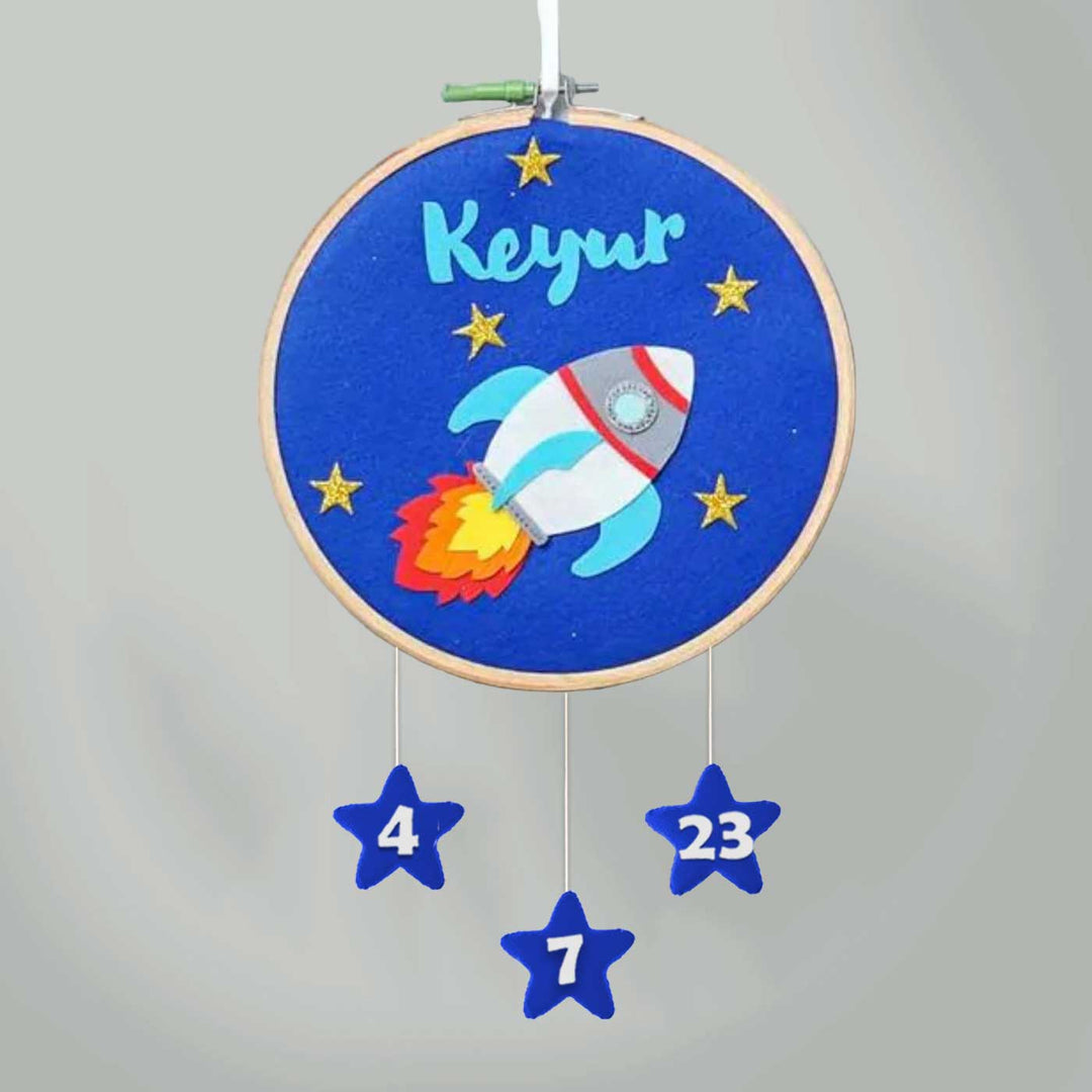 Handcrafted Personalized Rocket Hoop Nameplate - Front View Hanging with Date Stars