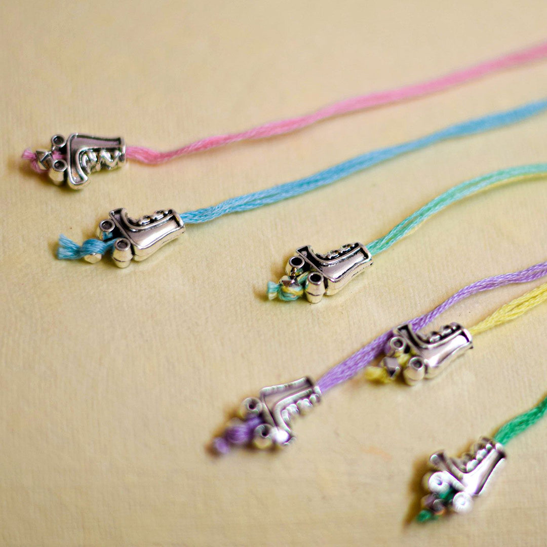 Handmade Stake Board Shoe And Pearl Design Rakhi With Roli Chawal - Close-up of roller skate charm