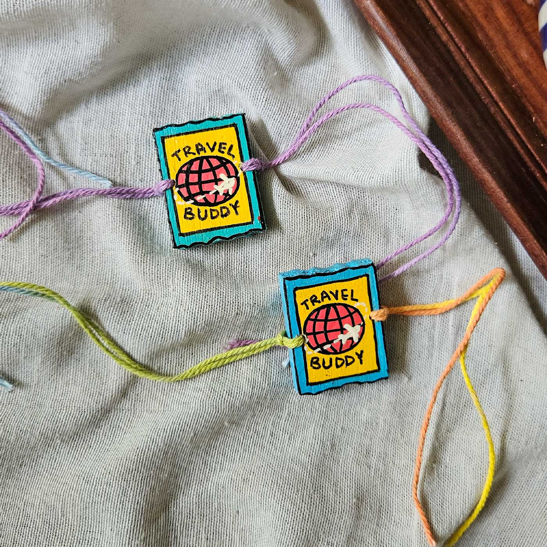 Handpainted Quirky Wooden Rakhi With Roli Chawal 6 New - Two bracelets laid flat on fabric