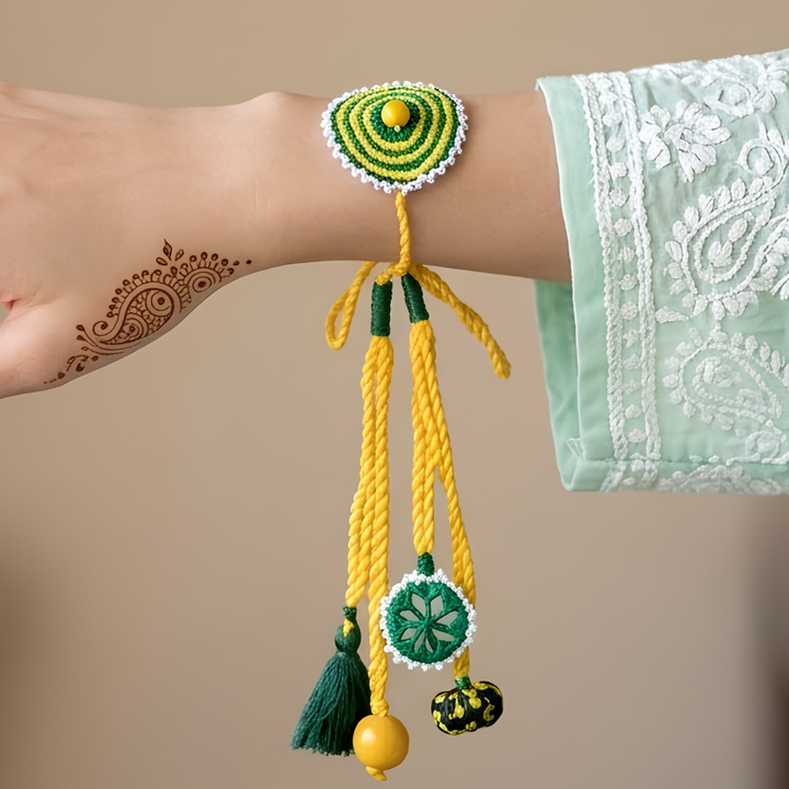 Handmade Reusable Yellow And Green Mirror And Jhumki Cotton Rope Lumba Rakhi For Bhabhi