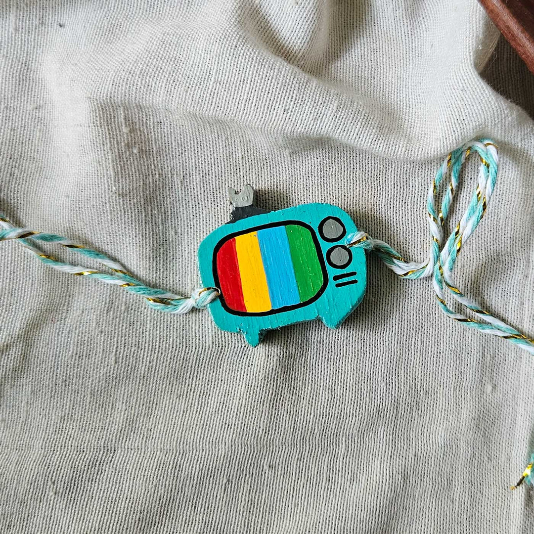 Handpainted Quirky Wooden Rakhi With Roli Chawal 7 New - TV charm with string laid out