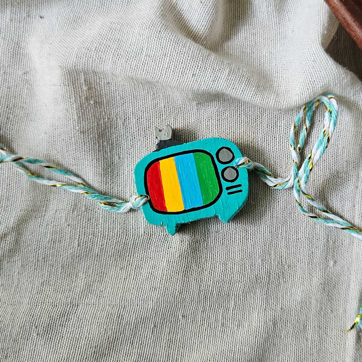 Handpainted Quirky Wooden Rakhi With Roli Chawal 7 New - TV charm with string laid out