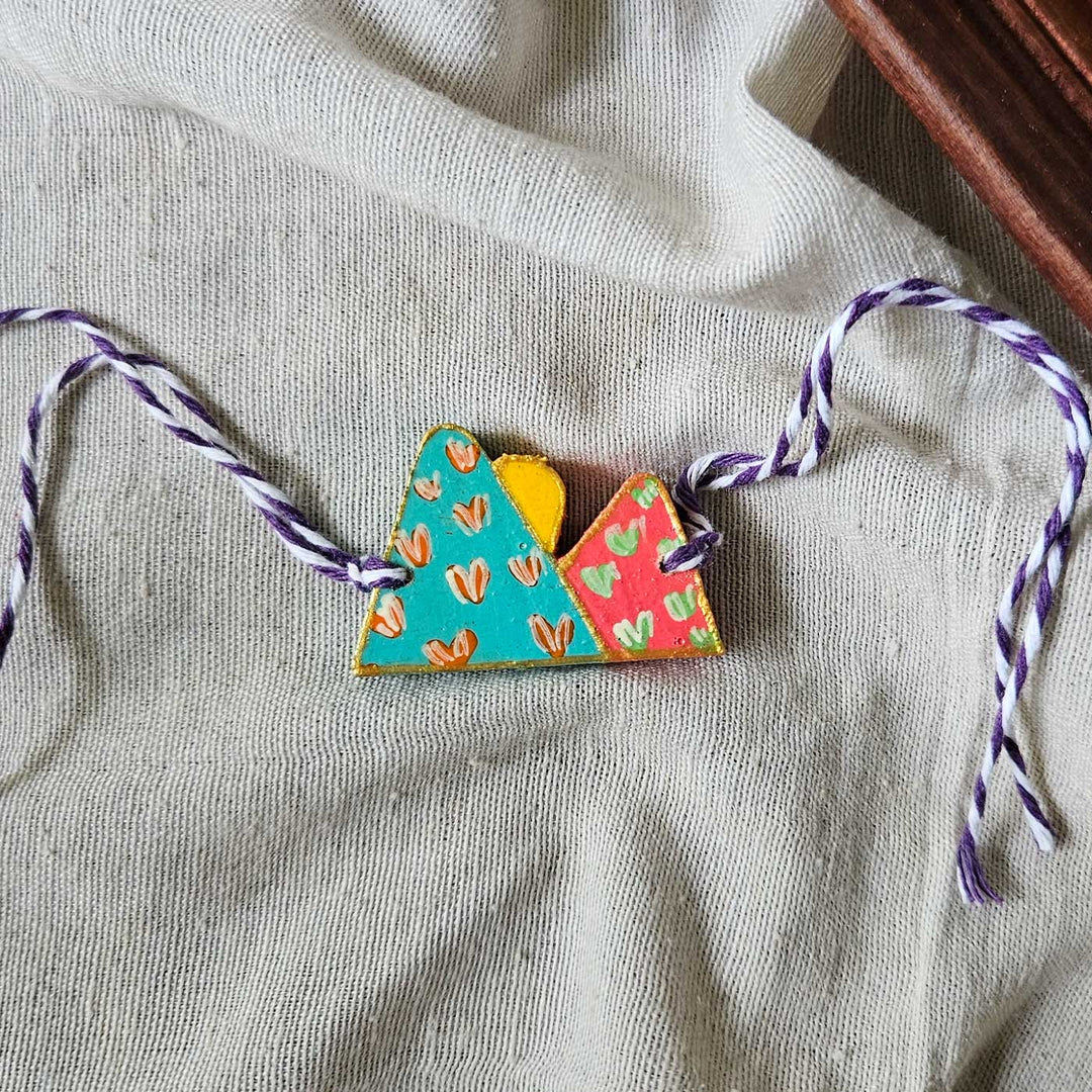 Handpainted Quirky Wooden Rakhi With Roli Chawal 9 New - Flat Lay with Full Strings Visible