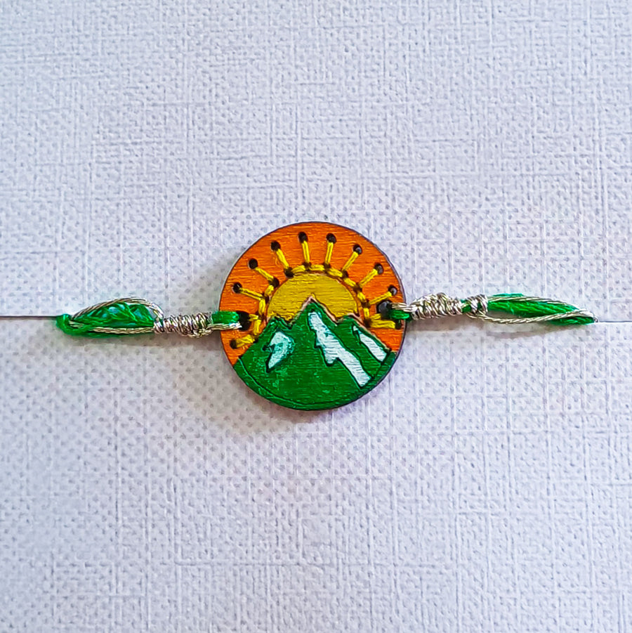 Handmade Green Mountain And Sun Wooden Rakhi With Roli Chawal For Brother - Front View