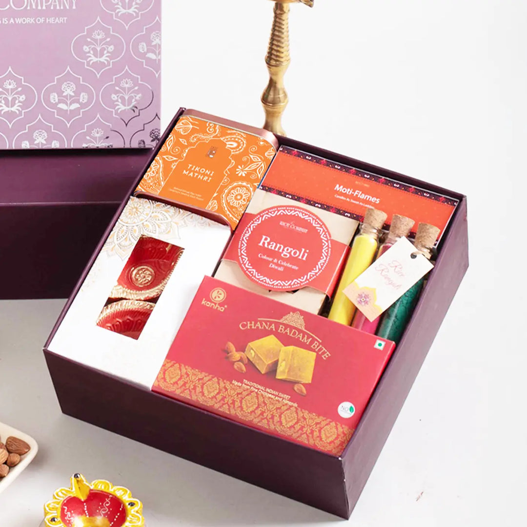 Festive Diwali Gift Hamper | Includes 2 Terracotta Diyas, 4 Rangoli Stencils, 3 Rangoli Color Tubes, 4 Ladoo Candles, 1 Chana Badam Bites, 1 Tikoni Mathri, 1 Gift Box