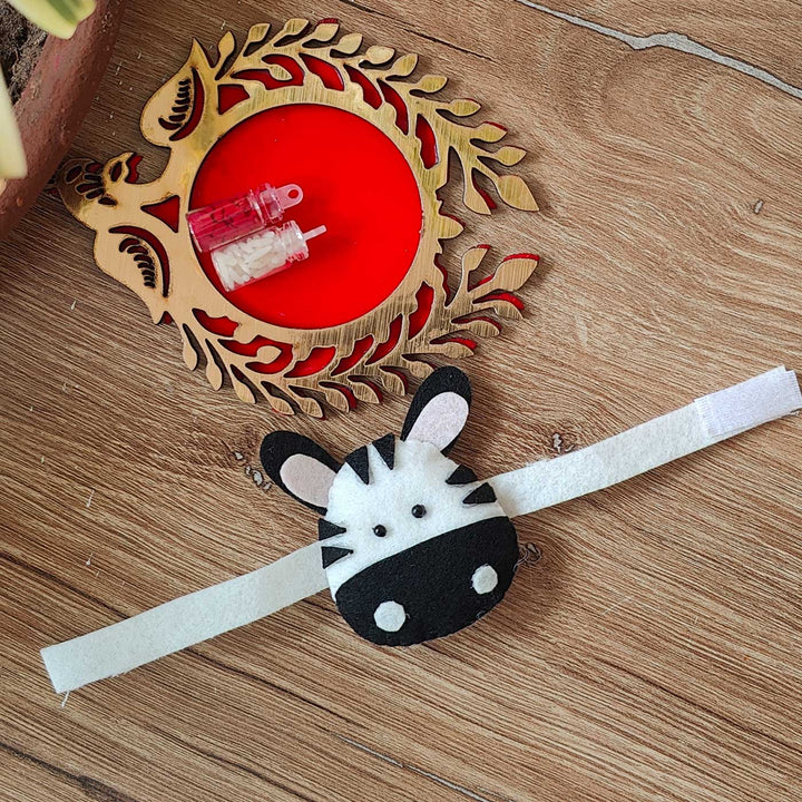 Handmade Zebra Theme Felt Kids Rakhi With Roli Chawal - Full View on Surface