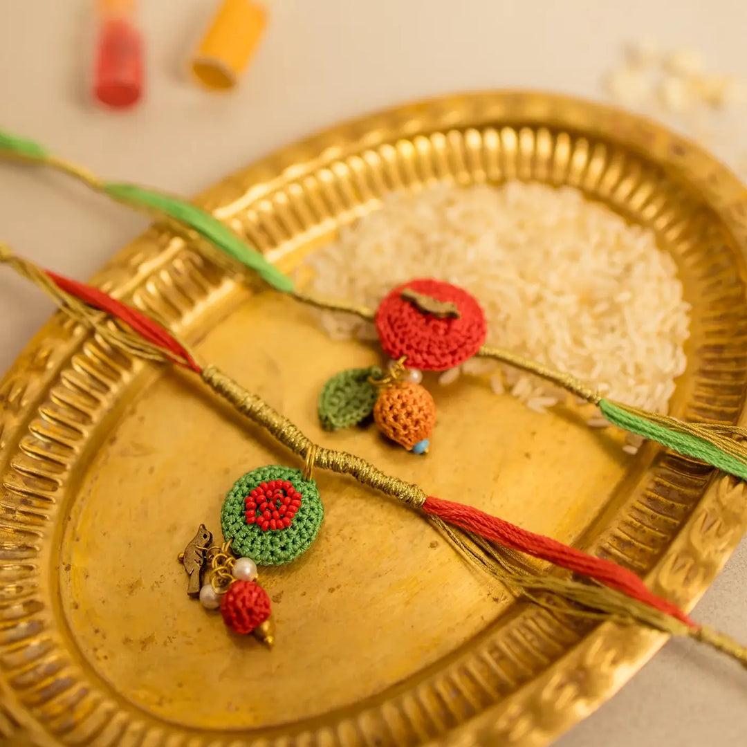 Handmade Crochet Ananya Flower And Golden Bird Rakhi With Roli Chawal Set Of 2 - Close-up View Showing Details