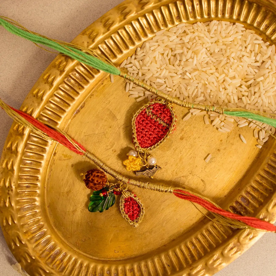 Handmade Crochet Ananya Paati Rakhi With Roli Chawal Set Of 2 - Close-up of Twin Rakhi Threads