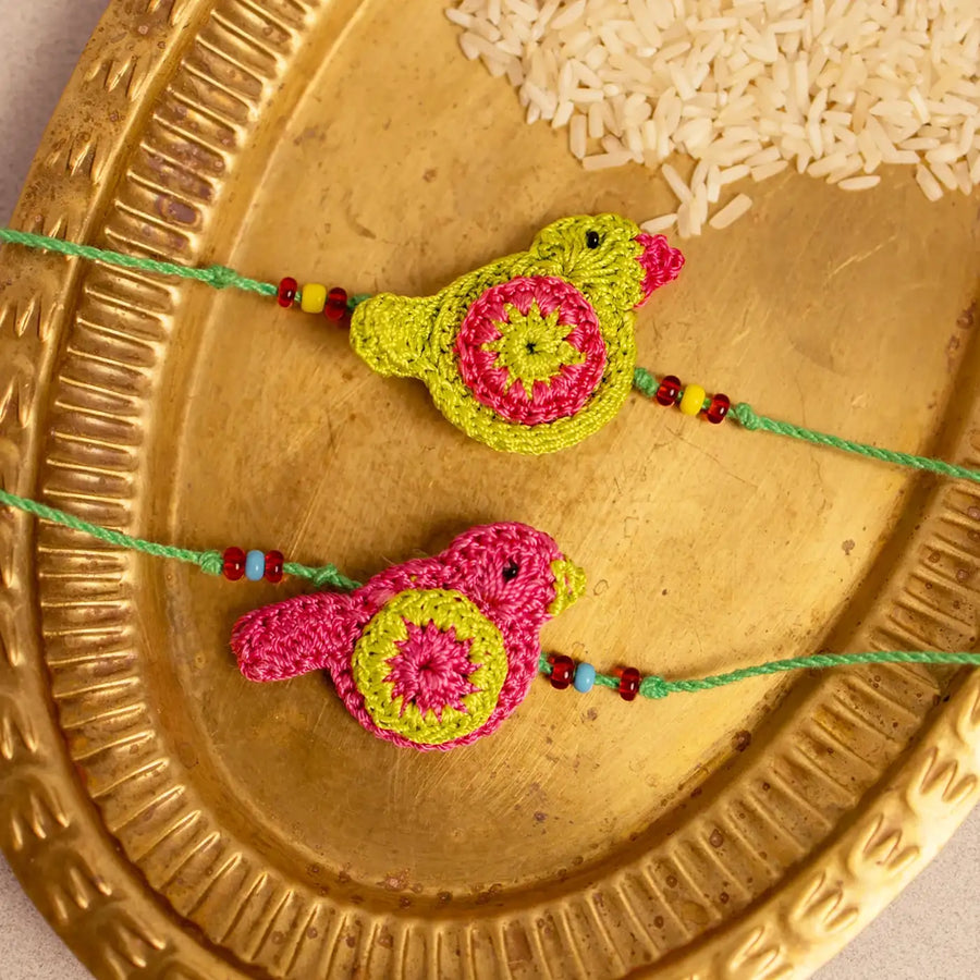 Handmade Crochet Green And Pink Birds Rakhi With Roli Chawal Set Of 2 - Close-up of Bird Rakhi Details