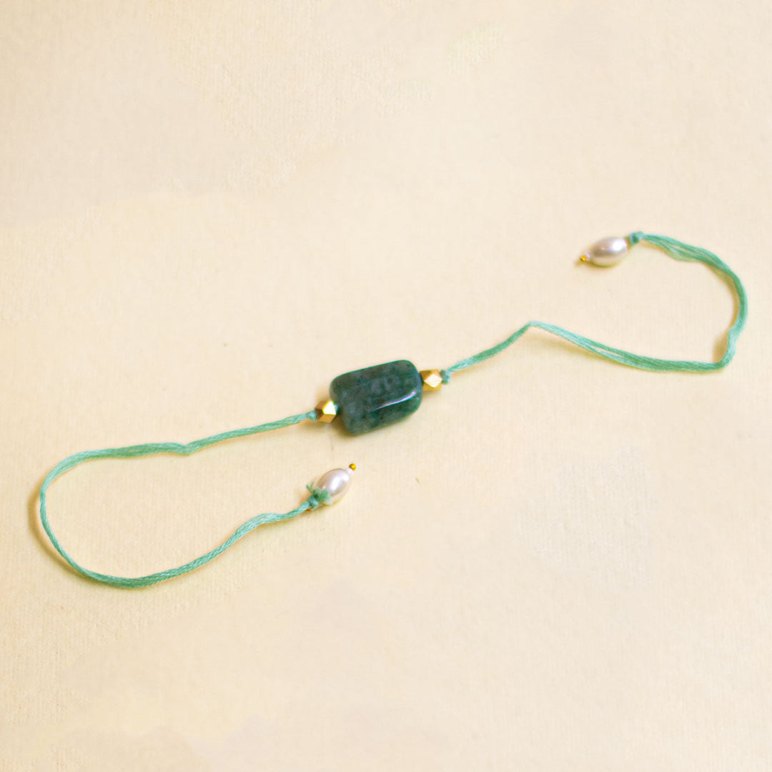 Handmade Reusable White Floral Bliss Bhaiya Bhabhi Rakhi With Roli Chawal - Green Bead Bracelet Front View