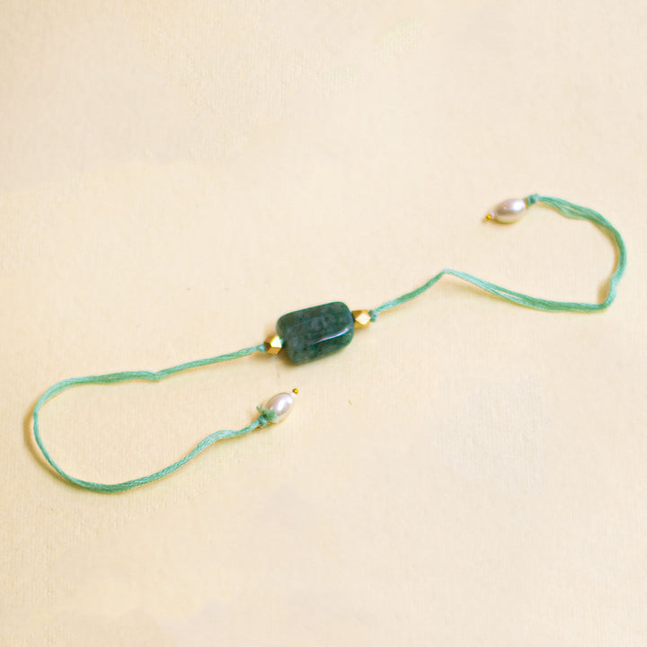 Handmade Reusable White Floral Bliss Bhaiya Bhabhi Rakhi With Roli Chawal - Green Bead Bracelet Front View