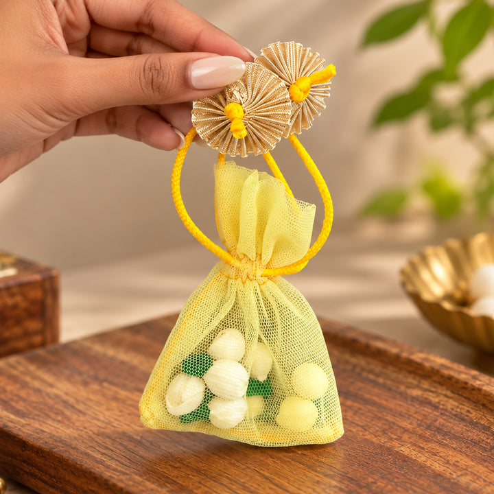 Hand-embellished Yellow Floral Net Potli With Shola Flowers For Festive Gifting