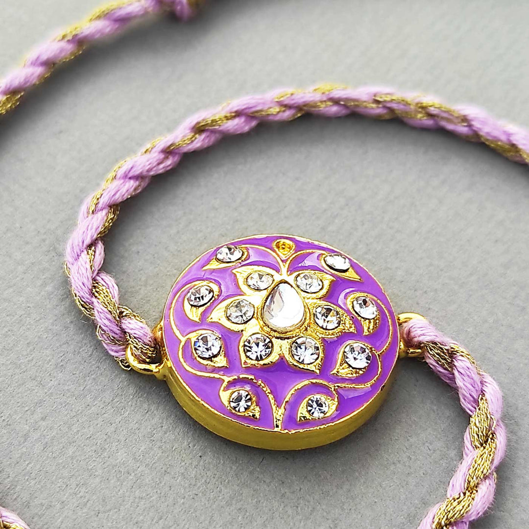 Handmade Meenakari Purple Buta Brass Rakhi With Roli Chawal - Front View with Twisted Cord