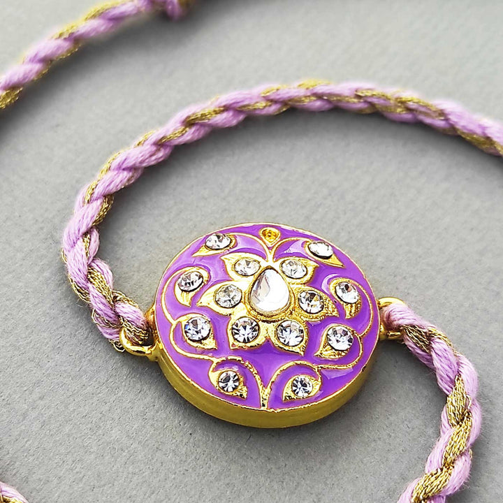 Handmade Meenakari Purple Buta Brass Rakhi With Roli Chawal - Front View with Twisted Cord