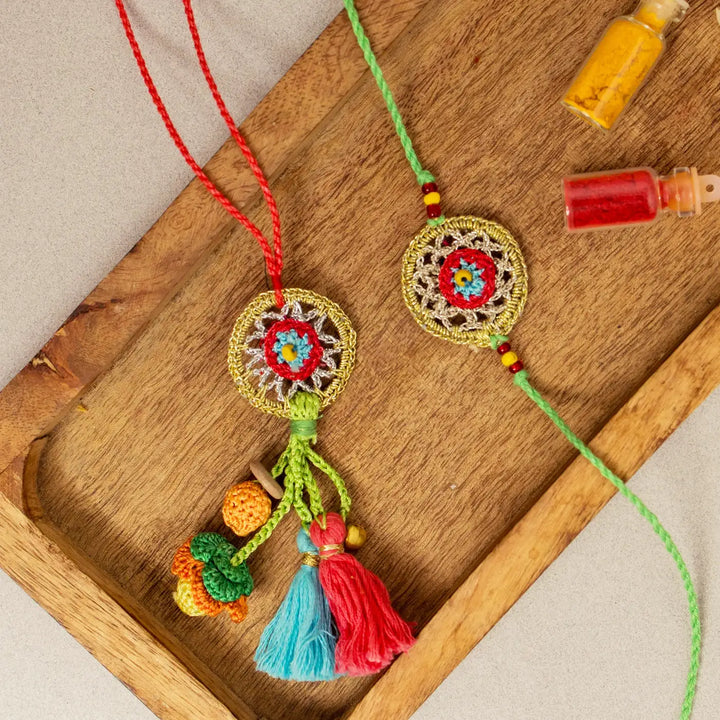 Handmade Crochet Gold Dreamcatcher Bhaiya Bhabhi Rakhi With Roli Chawal Set Of 2 - Close-up on Wooden Tray