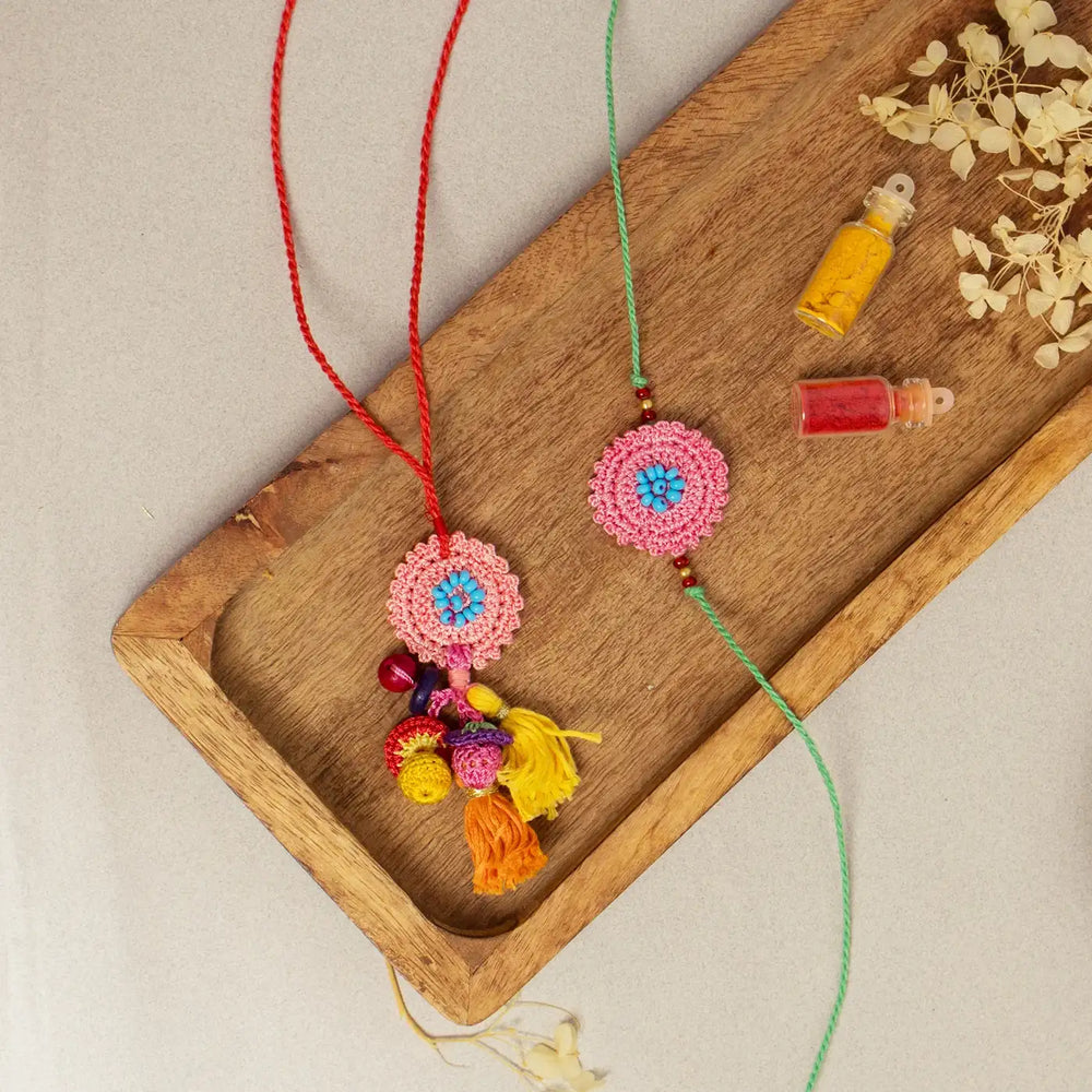 Handmade Crochet Pink Poppy Bhaiya Bhabhi Rakhi With Roli Chawal Set Of 2 - Top View with Accessories
