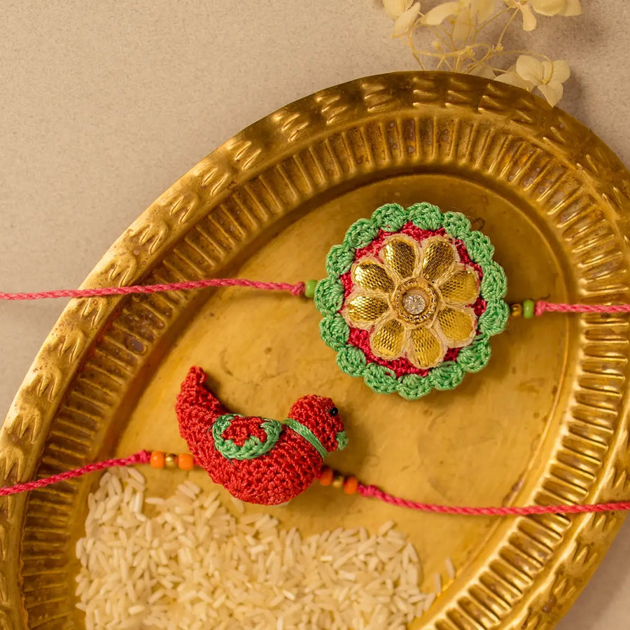 Handmade Crochet Bird And Flower Rakhi With Roli Chawal Set Of 2 - Close-up of Two Rakhi Designs
