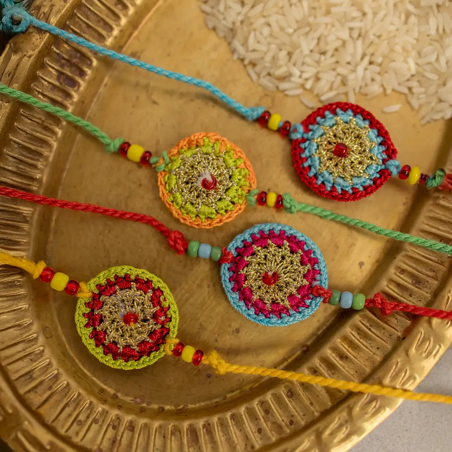 Handmade Crochet Multicolour Mandala Rakhi With Roli Chawal Set Of 4 - Close-up of Four Bracelets