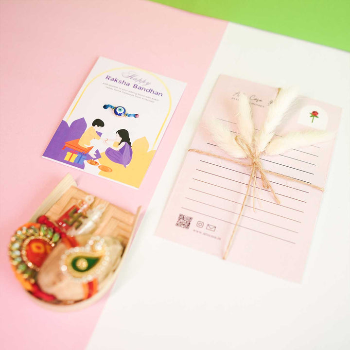 Personalized Handmade Crochet Yellow Lily Rakhi Hamper Includes 1 Crochet Flower 1 Message Card And 1 Rakhi And Roli Chawal - Product Components with Cards Top View