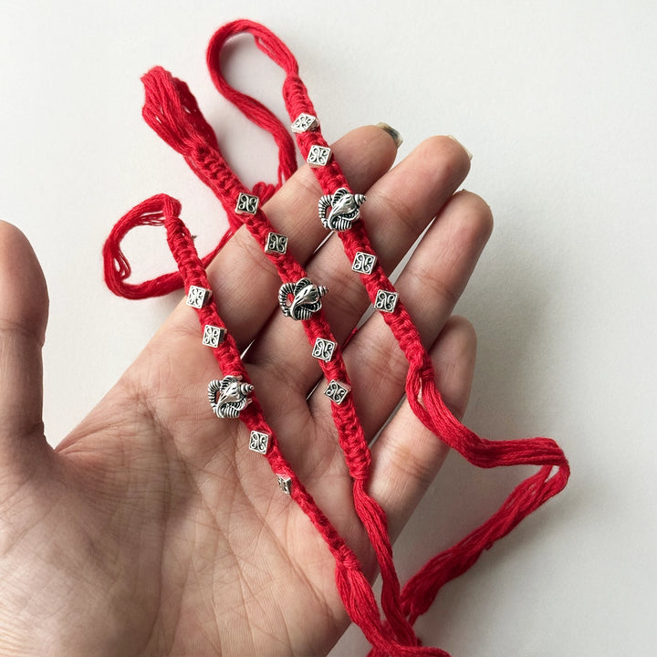 Handmade Ganpati Motif Rakhi With Roli Chawal - Held in hand showing length