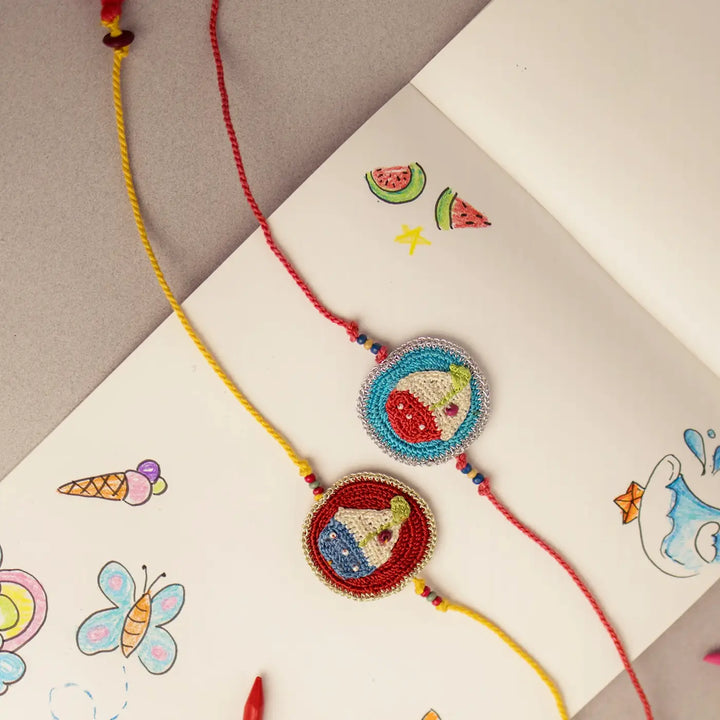 Handmade Crochet Boat Theme Kids Rakhi With Roli Chawal Set Of 2 - Angled View of Two Bracelets