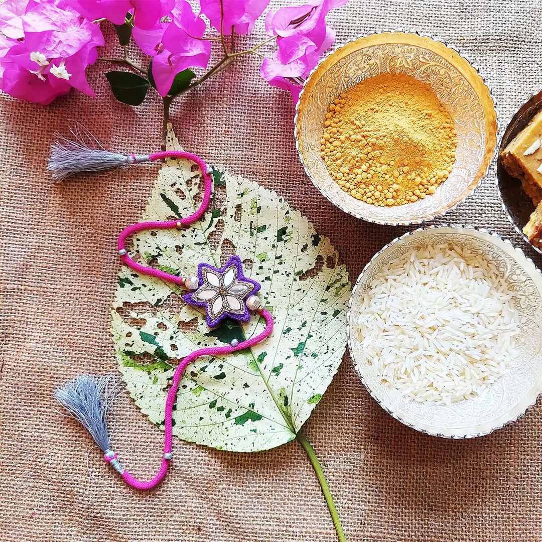 Handmade Mirror Work Flower Rakhi With Roli Chawal - Styled Flat Lay with Accessories (11)