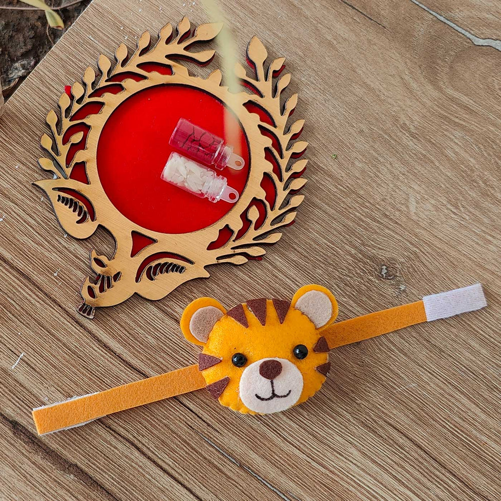 Handmade Tiger Theme Felt Kids Rakhi With Roli Chawal - Front View with surroundings visible