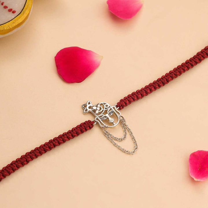 Handmade Krishna Design Religious Silver Rakhi For Brother - Laid Flat with Decorations