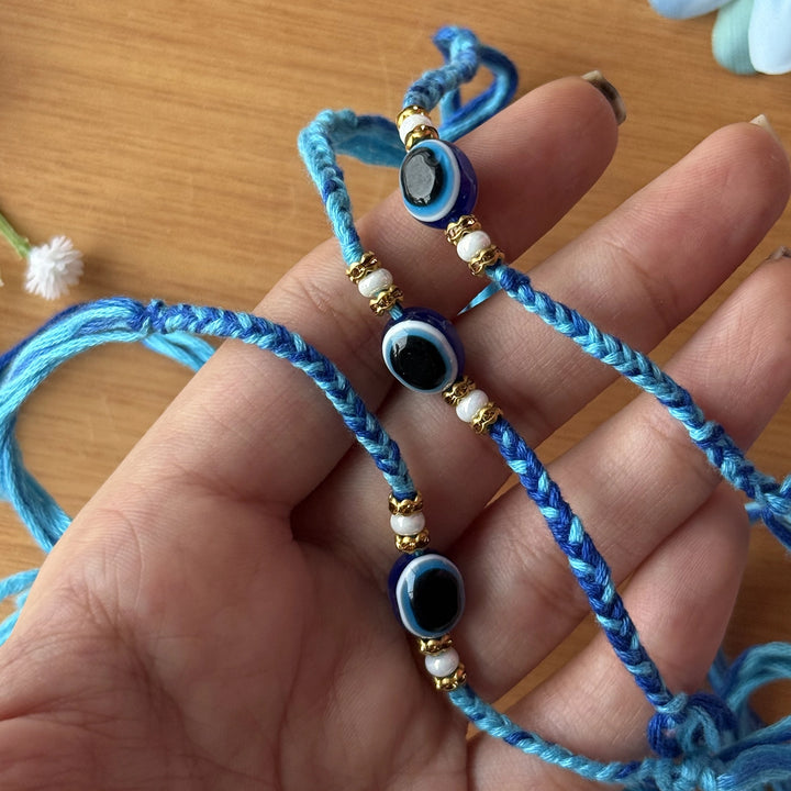 Handmade Beaded Evil Eye Rakhi With Roli Chawal - Bracelets Held in Hand
