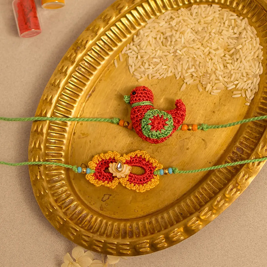 Handmade Crochet Paakhi And Phool Rakhi With Roli Chawal Set Of 2 - Close-up of Rakhi designs