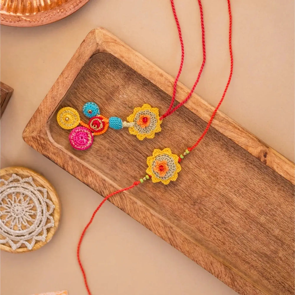 Handmade Crochet Yellow Basant Bhaiya Bhabhi Rakhi With Roli Chawal Set Of 2 - Top View Showing Both Rakhis