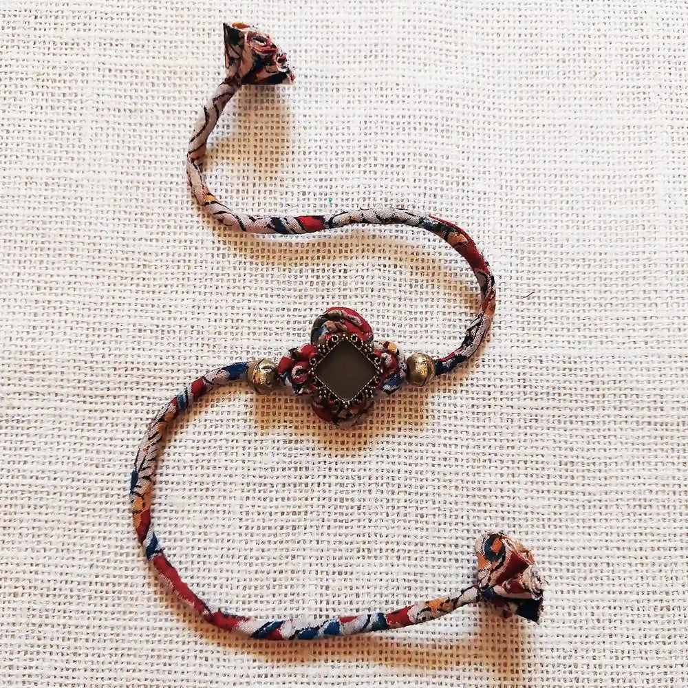 Handmade Dori Work Kalamkari Bhaiya Bhabhi Rakhi With Roli Chawal Set Of 2 - Bracelet Alone Front View