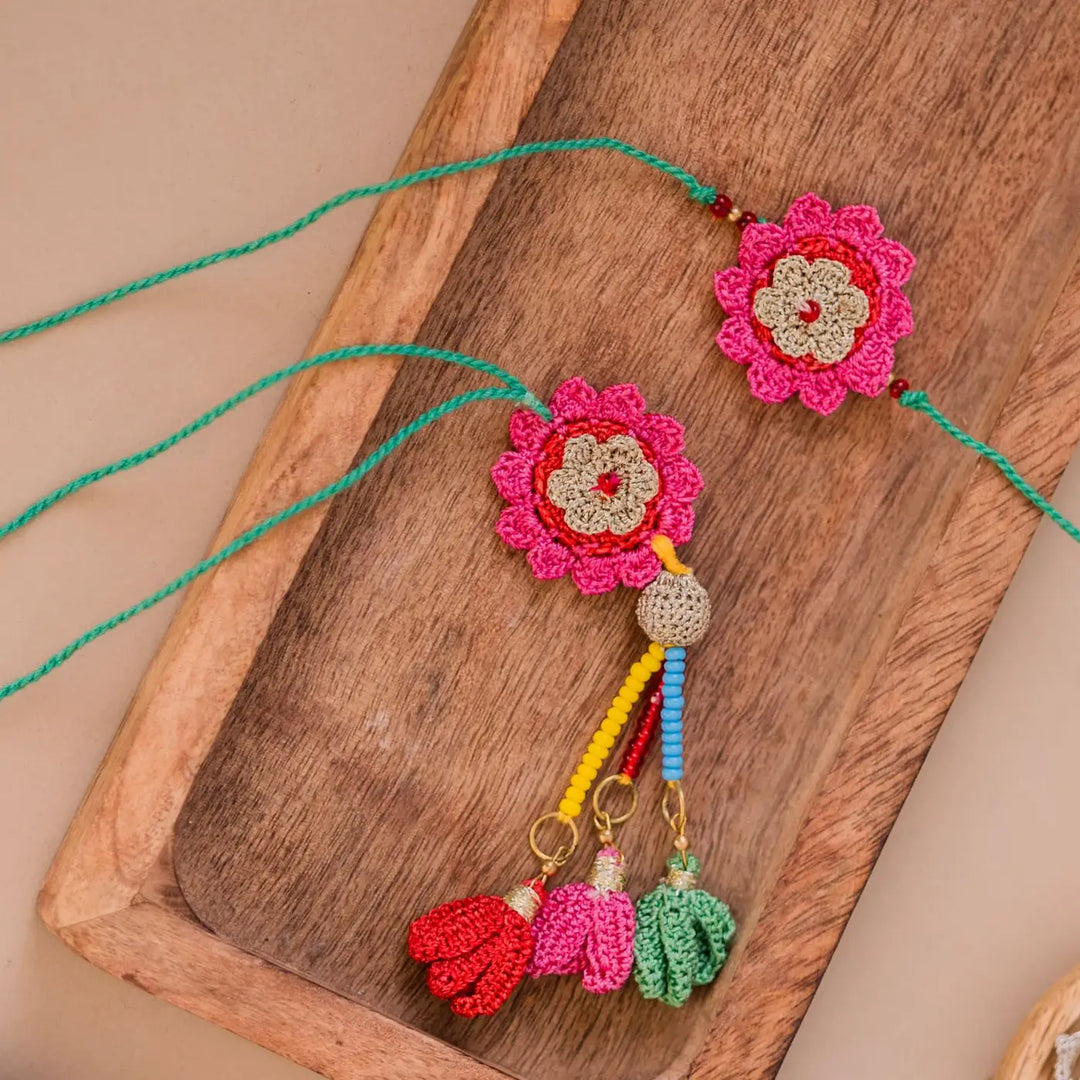 Handmade Crochet Pink Bougainvillea Bhaiya Bhabhi Rakhi With Roli Chawal Set Of 2 - Detailed View of Tassels and Rings
