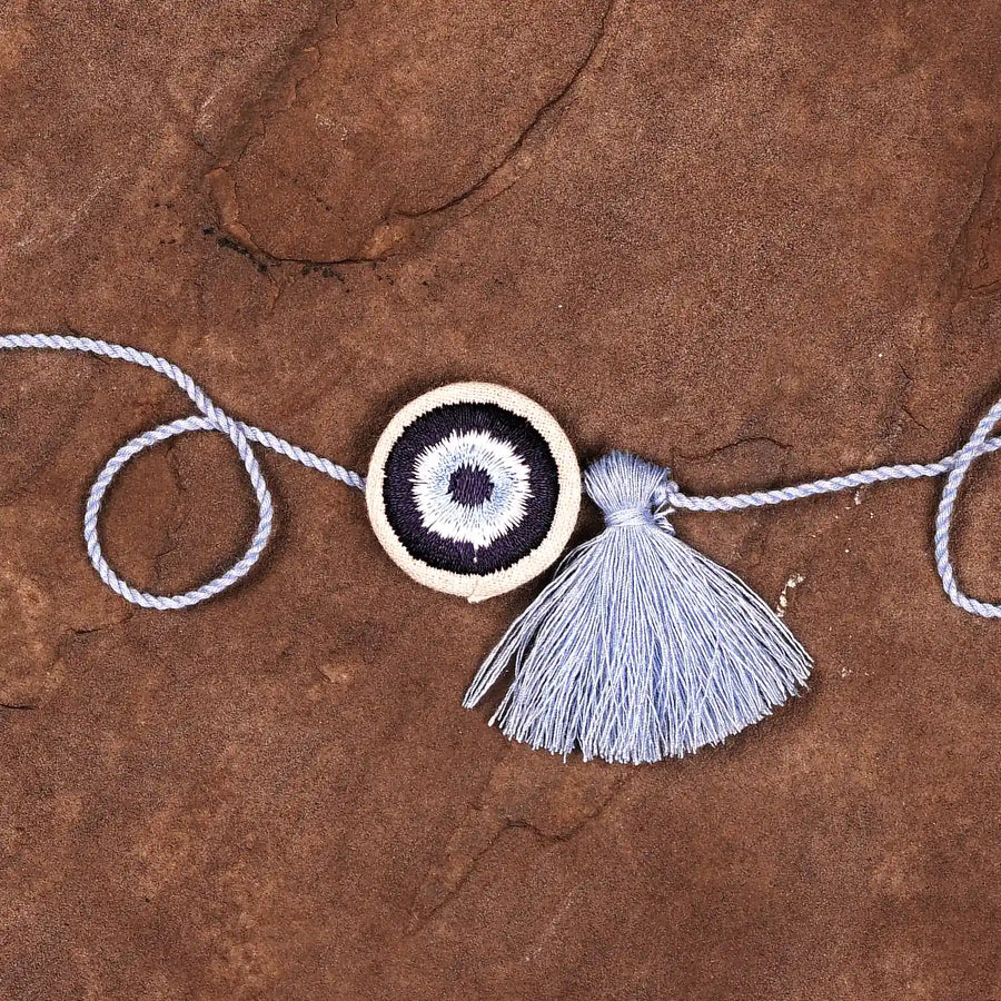 Hand Embroidered Evil Eye Rakhi With Roli Chawal - Close-up of central design